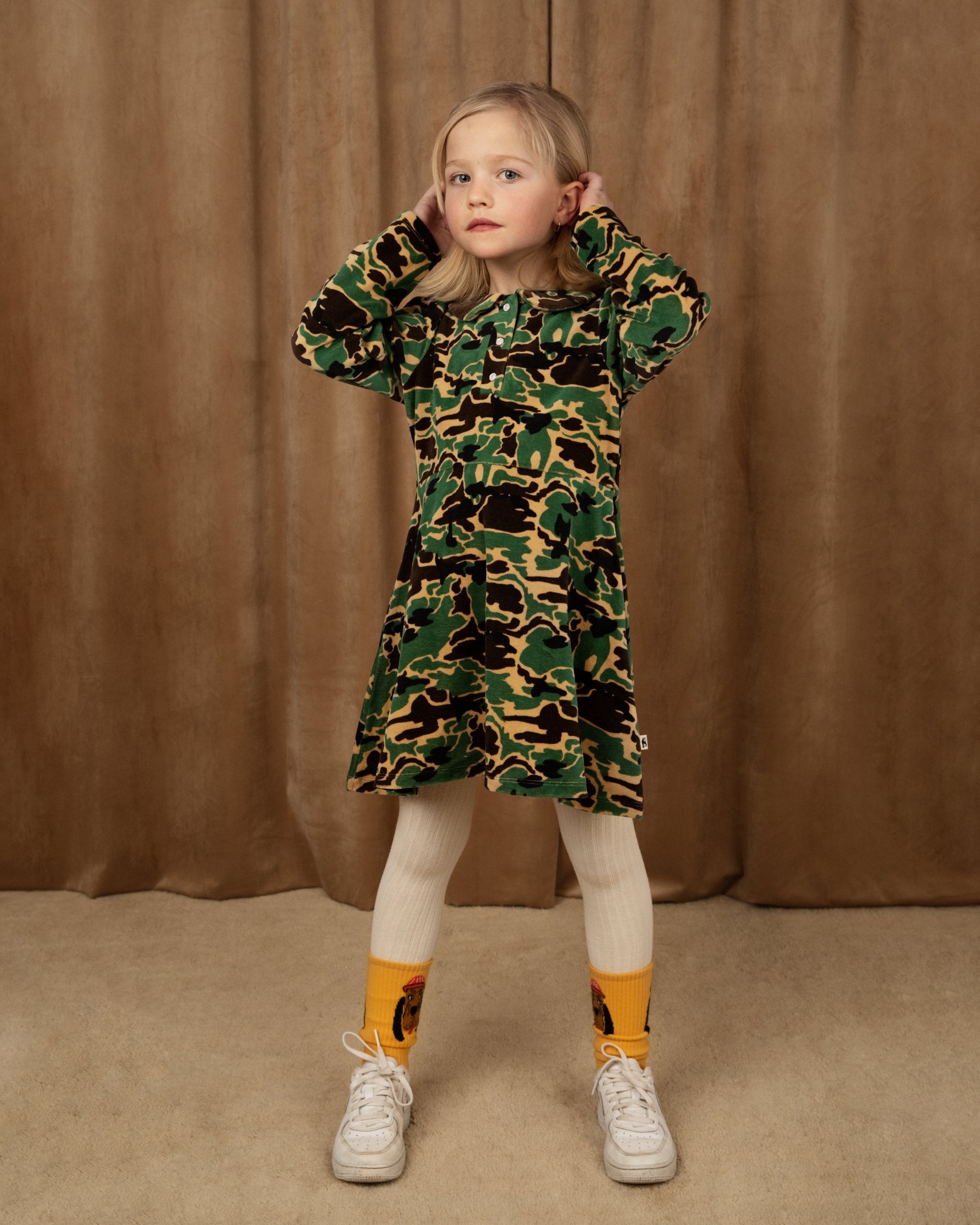 MINI RODINI - velour green camouflage print dress with white tights and yellow socks and trainers